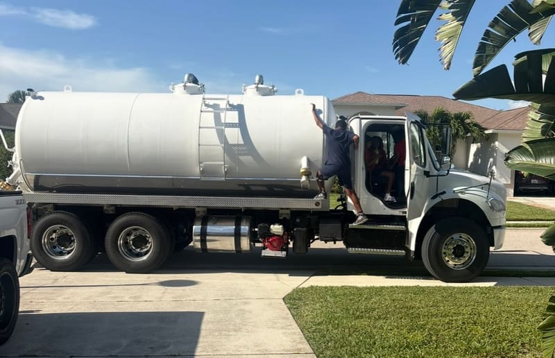 Xpress Septic Tank Pumping vacuum truck and crew at a residential job